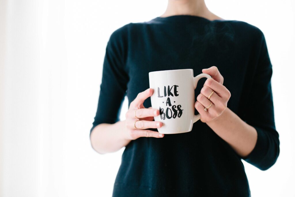 Lady holding a coffee cup that says "Like a Boss"