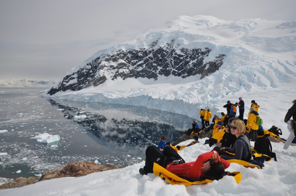 People on Snow Topped Iceberg