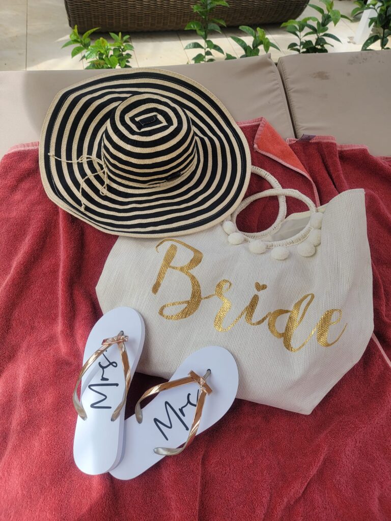 Beach bag, hat & flip flops that say Bride & Mr & Mrs on them