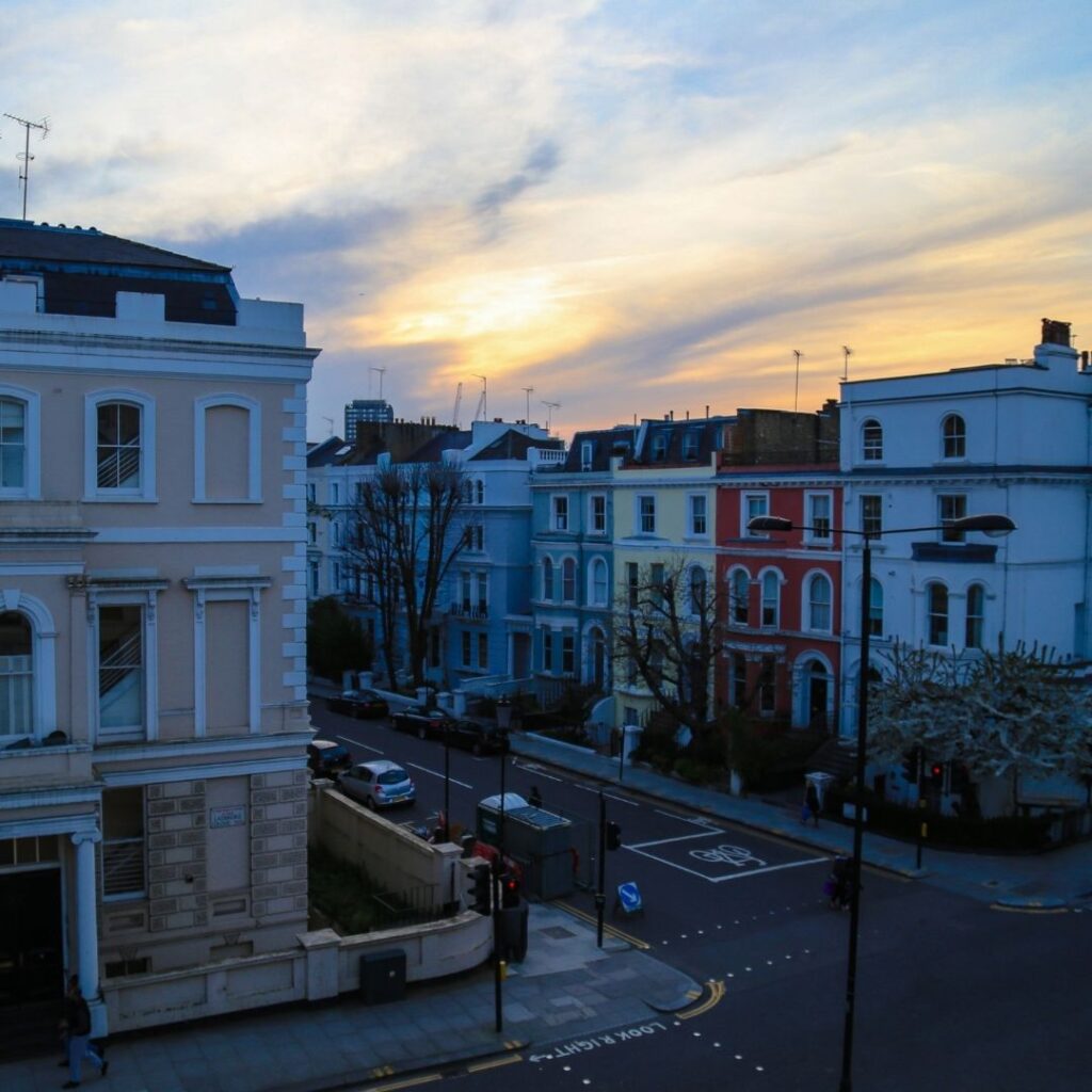 A street in Nottinghill with beautiful old colorful buildings. They look very rega.