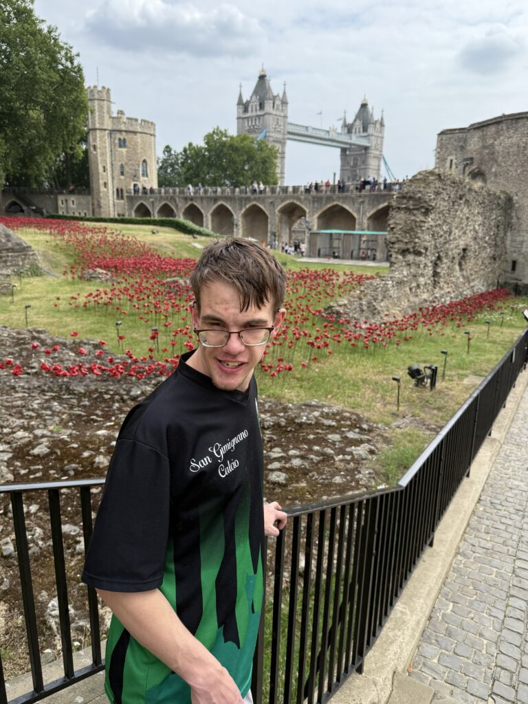 Aaron in front of the Tower of London with the Tower bridge in the background.