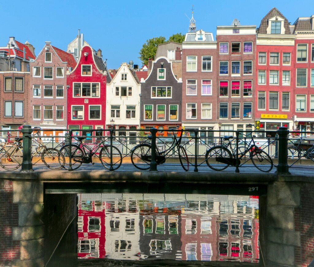 Cycle s on a bridge in Amsterdam by Guarav Jain on Unsplash
