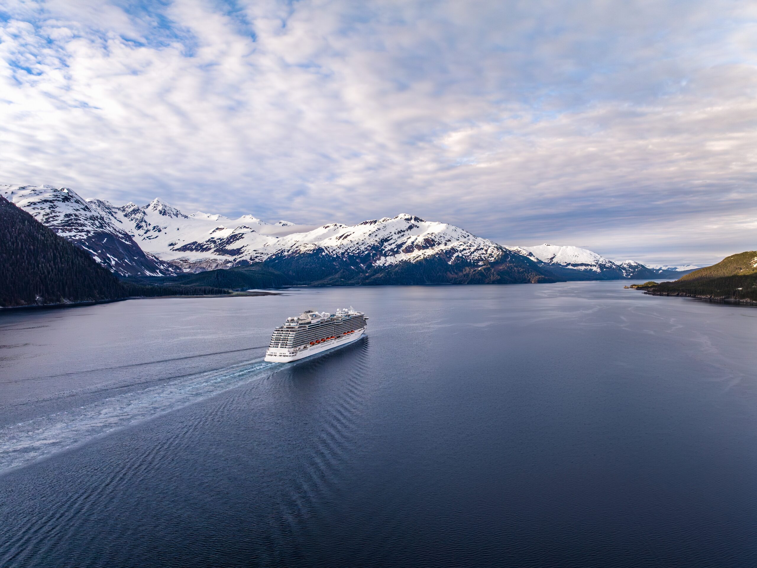 Alaska cruise ship sailing through a fjord on an Alaska cruise and land tour