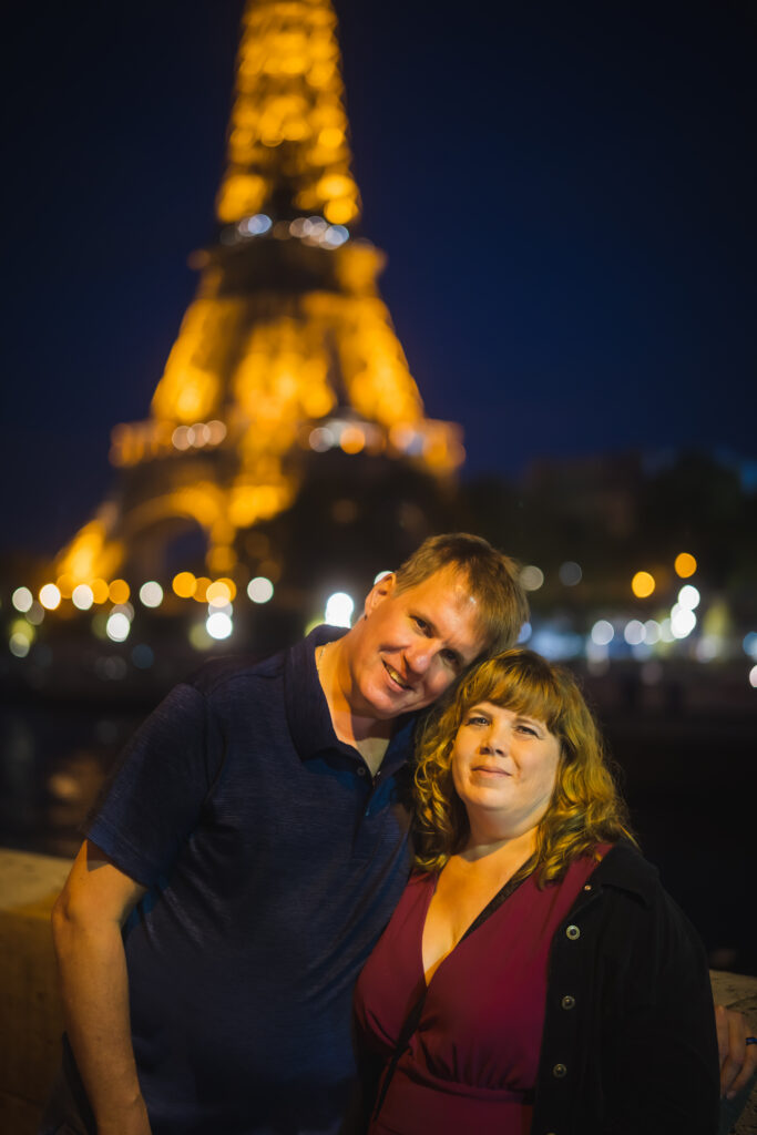 CCouple smiling Eiffel Tower Paris — Italy and Paris anniversary trip