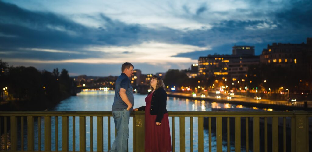 Couple Italy Paris anniversary trip — Eiffel Tower lit at night