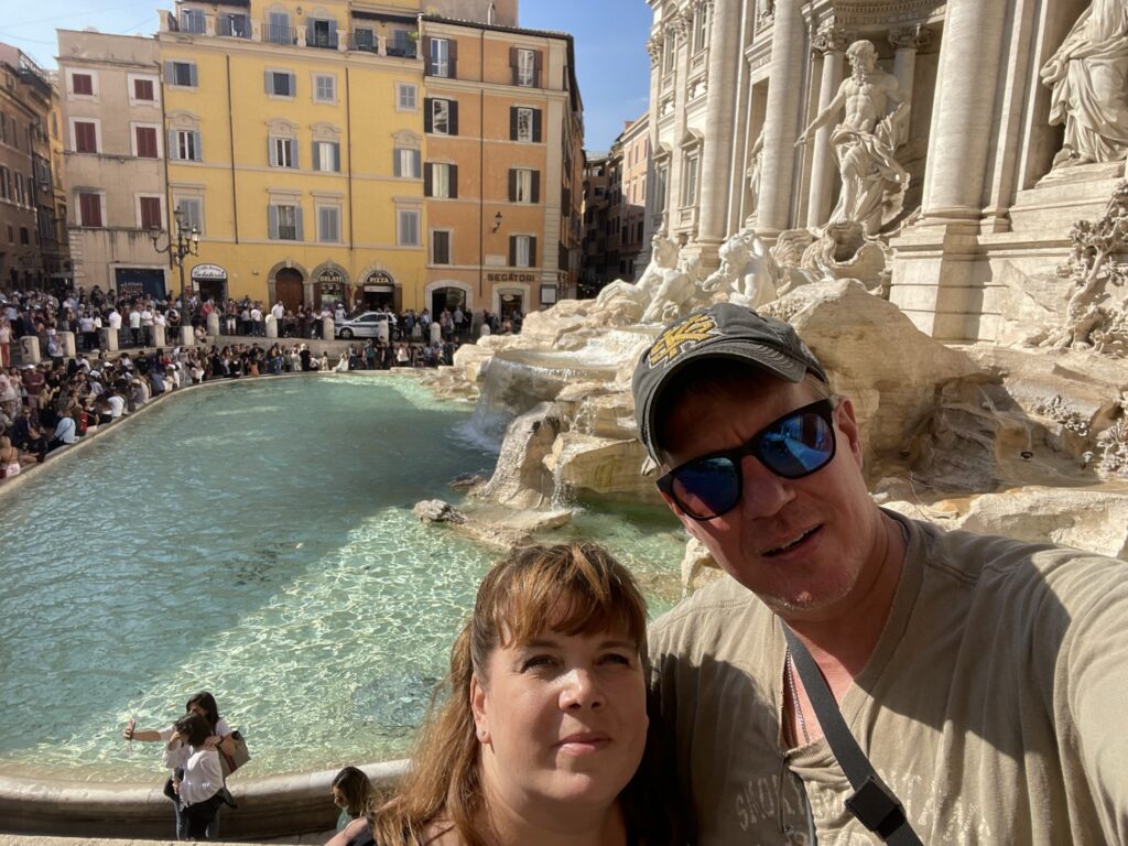 Couple in front of the Trevi fountain.