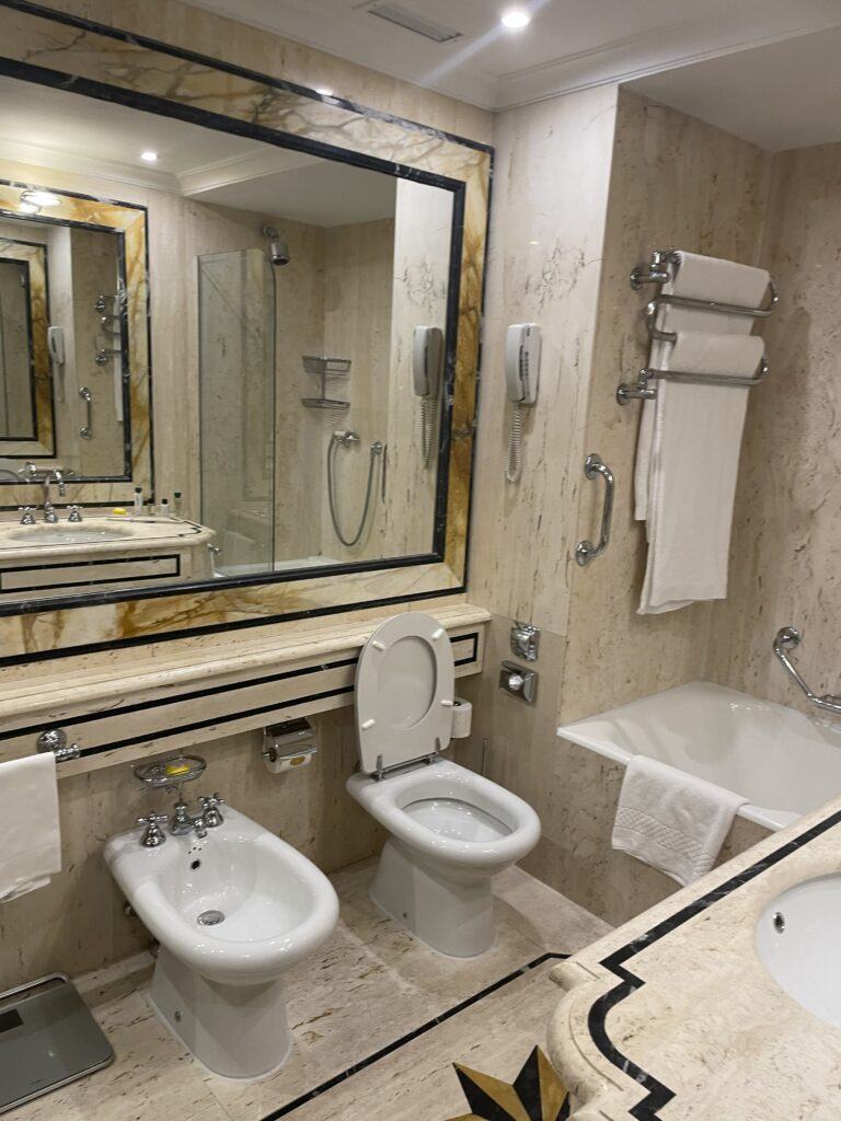 Waldorf marble bathroom: "Waldorf Astoria Rome marble bathroom gold fixtures luxury"
