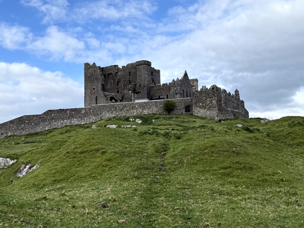 Ireland travel tips: Rock of Cashel at golden hour with sheep grazing in the foreground, County Tipperary Ireland