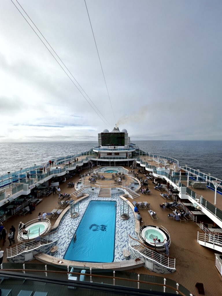 View from a cruise ship balcony cabin overlooking the stunning mountain and glacier scenery of Alaska's Inside Passage