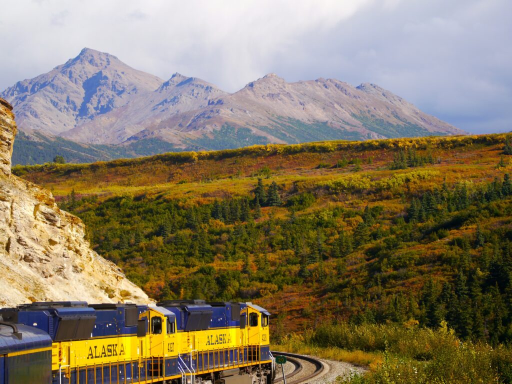 Alaska shore excursions Skagway: White Pass Railroad train winding through mountain scenery