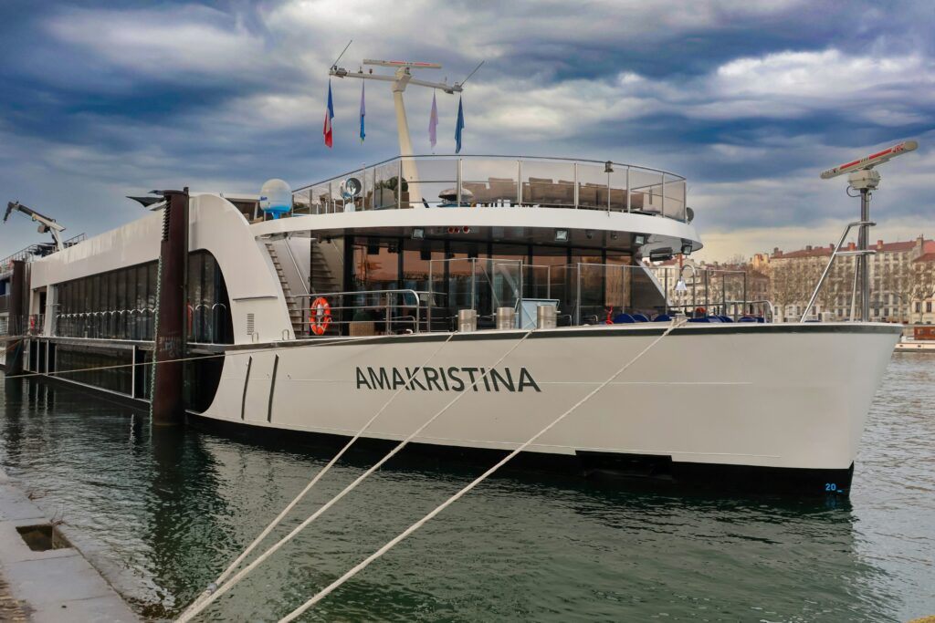 AMA Waterways cruise ship docked in a European port town.