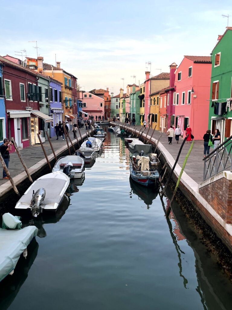 Colorful houses along the canal on Burano island, slow travel in Italy near VeniceColorful houses along the canal on Burano island near Venice