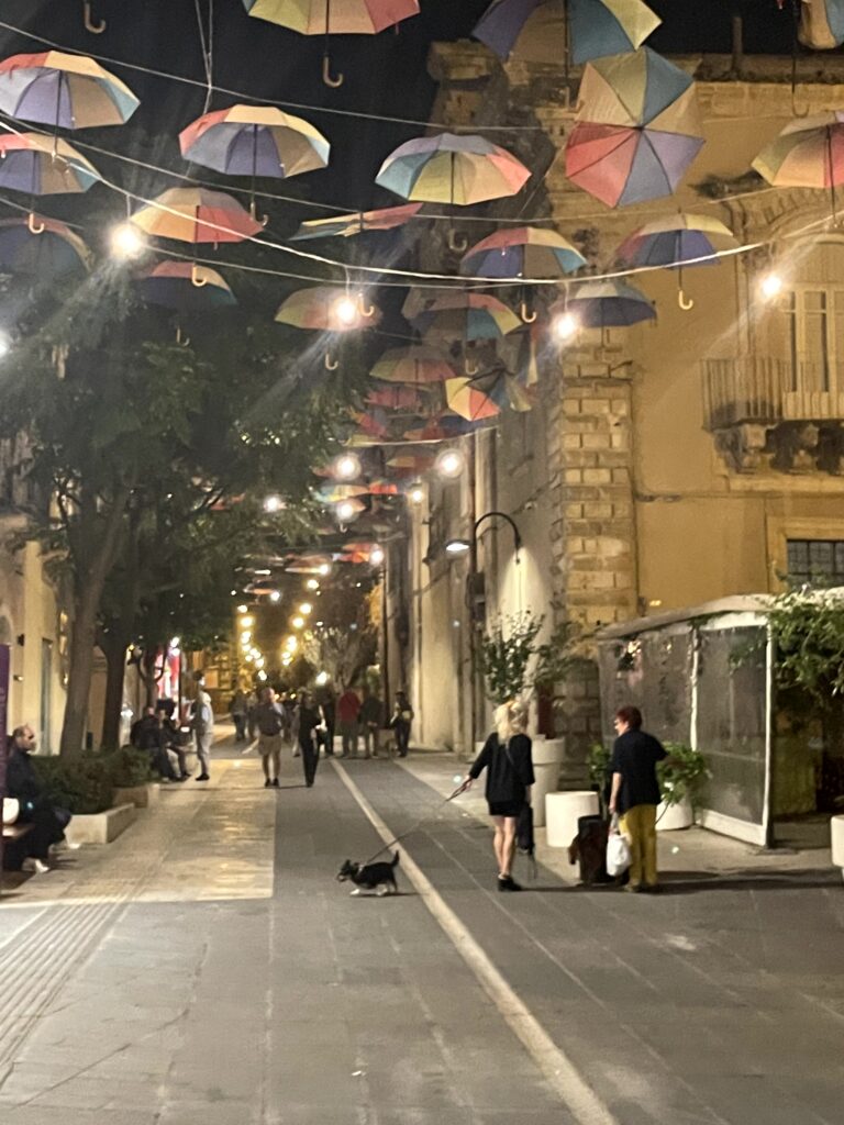 Slow travel in Italy: the umbrella-covered street in Ragusa, Sicily